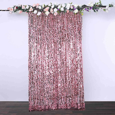 Pink sequin curtain with floral decoration overhead