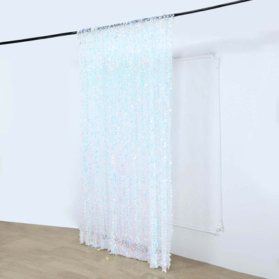 Iridescent sequin curtain hanging on a rod in a minimalist space.