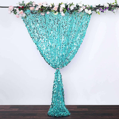 Turquoise sequin curtain with floral accents hanging elegantly.