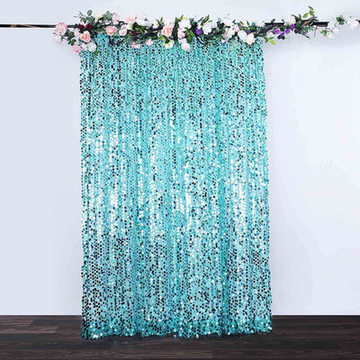 Turquoise sequin curtain with floral garland, perfect for events and decor.