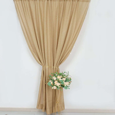 Beige curtain draped elegantly with a floral arrangement in a minimalist setting.