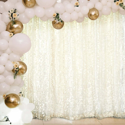 Elegant balloon arch with white and gold balloons over a shimmering backdrop.