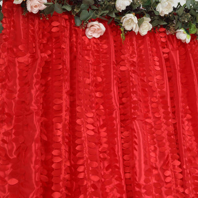 Red sequin backdrop with floral accents for events and photo settings.