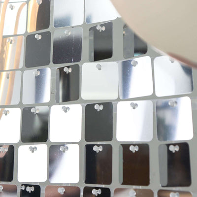 Reflective square mirror tiles arranged in a modern design.