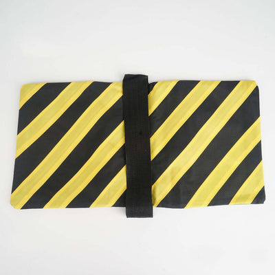 Black and yellow striped folding mat with a secure strap