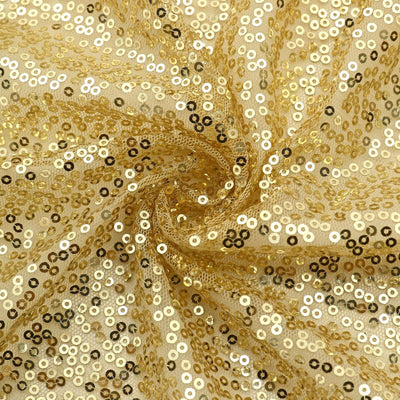 Gold sequin fabric with shimmering circular sequins in a swirling pattern.