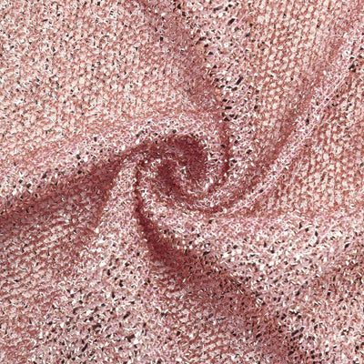 Textured pink fabric with sparkling threads in a swirling pattern.