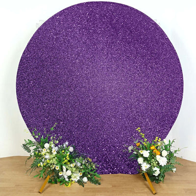 Purple glitter backdrop with floral arrangements on either side.