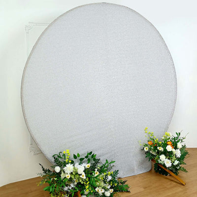 Decorative round silver backdrop with floral arrangements