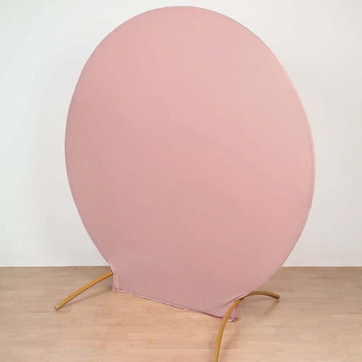 Round pink backdrop stand on a wooden floor.
