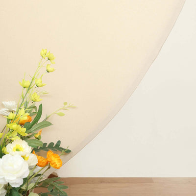 Floral arrangement with yellow and orange flowers on a neutral background.