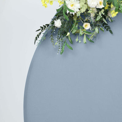 Floral arrangement with greenery on a round gray surface