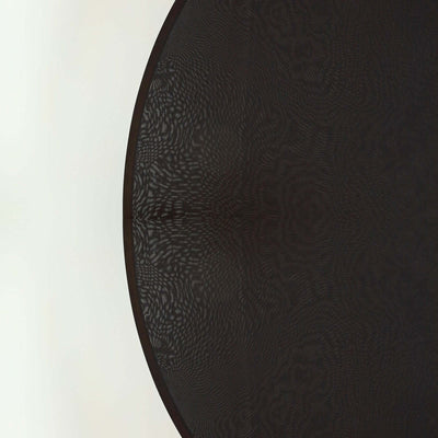Black patterned round table with a smooth surface.
