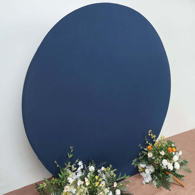 Navy blue round backdrop with flowers on a wooden surface.