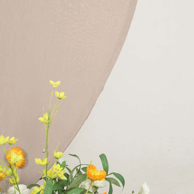 Beige backdrop with yellow and orange flowers in a floral arrangement.