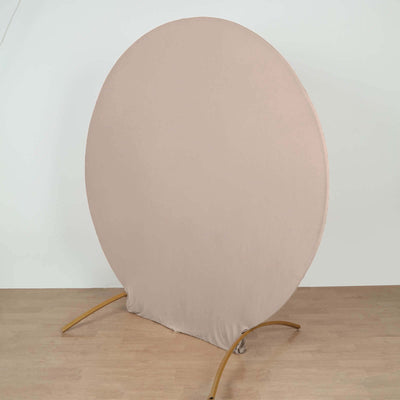 Round fabric backdrop on a stand for photography or staging purposes.