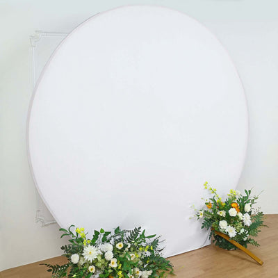 Round backdrop with floral arrangements on either side.