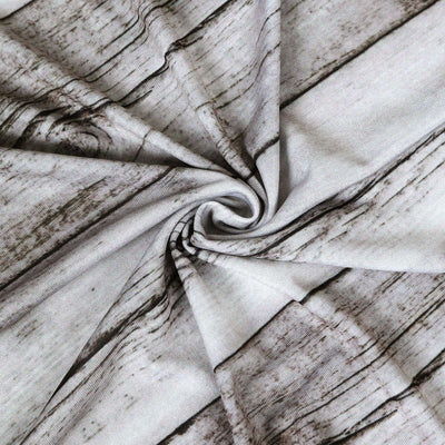 Textured fabric with a wood grain design in a spiral pattern.
