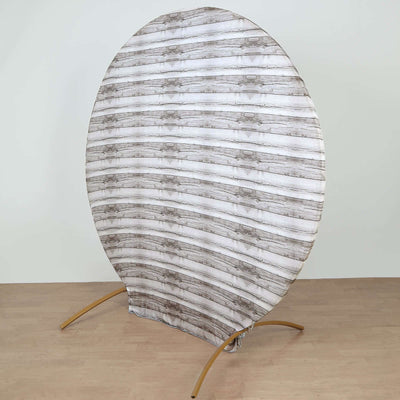 Round wooden-patterned backdrop on a gold stand for photography