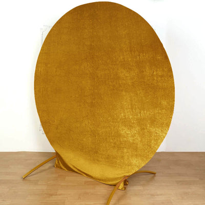 Gold circular backdrop on a stand for photography.