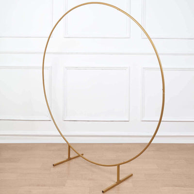 Gold metal circular display stand on a plain background.