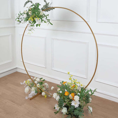 Floral hoop arch with greenery and flowers for events or photography setups.