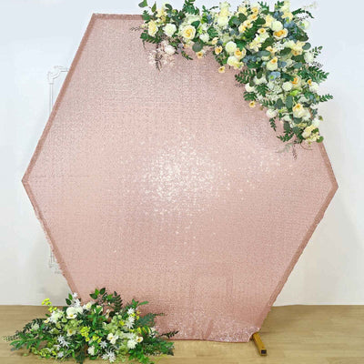 Rose gold hexagonal backdrop with floral accents for event decor.