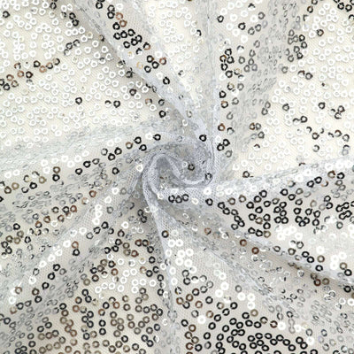 Silver sequin fabric with a shimmering pattern on a sheer background.