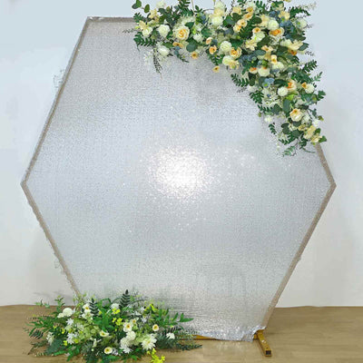 Hexagon-shaped backdrop with flowers for events and photography.