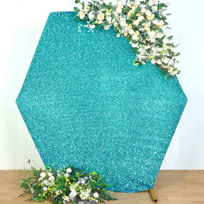 Hexagon glitter backdrop with floral accents for events and photography.