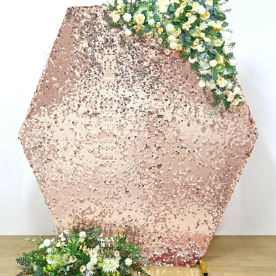 Rose gold hexagon sequin backdrop with floral accents for events and photography.