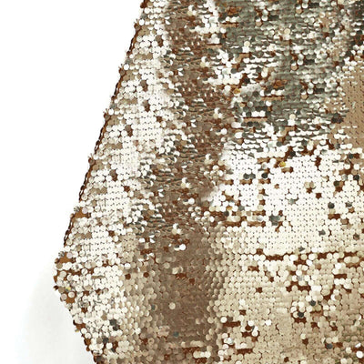 Gold sequin fabric with shimmering texture and reflective surface.