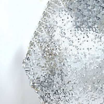 Silver sequin fabric close-up showing texture and shine.