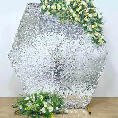 Hexagon-shaped silver sequin backdrop with floral accents for events and photography.