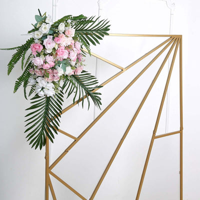 Gold geometric backdrop with artificial flowers and greenery