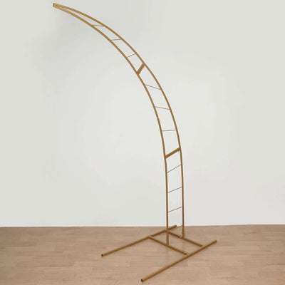 Gold metal arch display stand on a plain background.