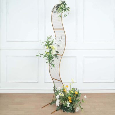 Curved plant display stand with flowers and greenery on a white background.