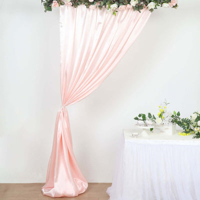 Pink satin curtain draped elegantly with floral accents