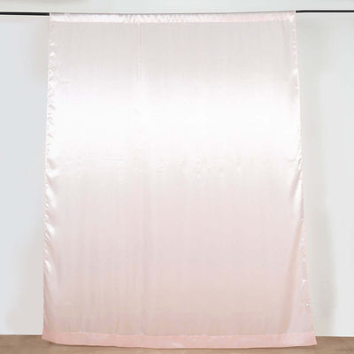 Soft pink satin curtain draped elegantly against a plain background.