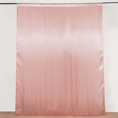 Pink satin curtain hanging against a plain backdrop
