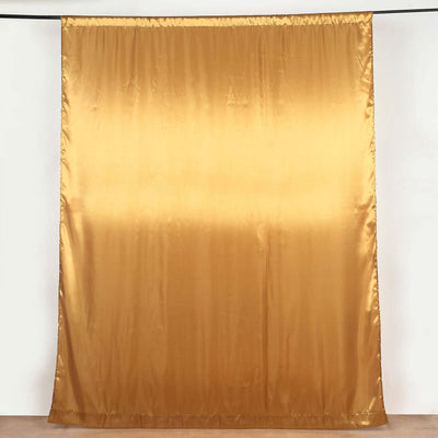 Gold satin curtain draped elegantly in a studio setting.