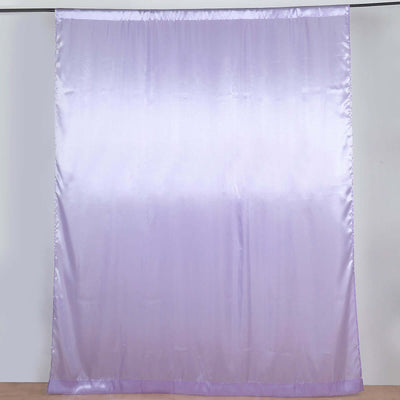 Lavender satin fabric drape hanging against a plain backdrop