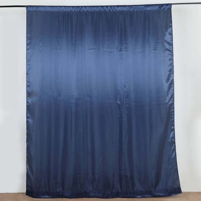 Navy blue satin curtain hanging on a rod