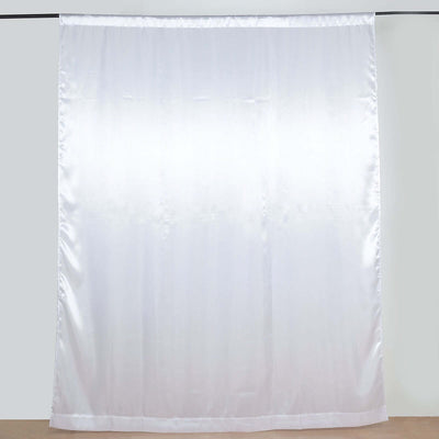 White satin curtain panel on a plain backdrop.