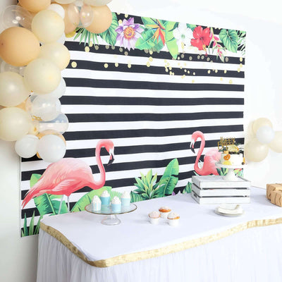 Flamingo-themed party backdrop with tropical leaves and balloons.