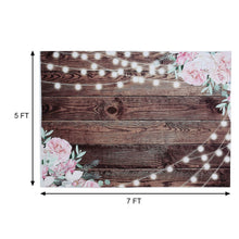 pink flowers and string lights on a wooden background