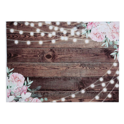 Floral and string light backdrop on a wooden surface