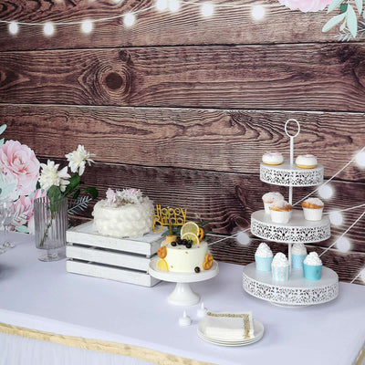 Birthday party dessert table with cake, cupcakes, and floral decor.