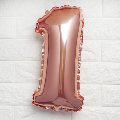 Rose gold number 1 balloon on a white backdrop