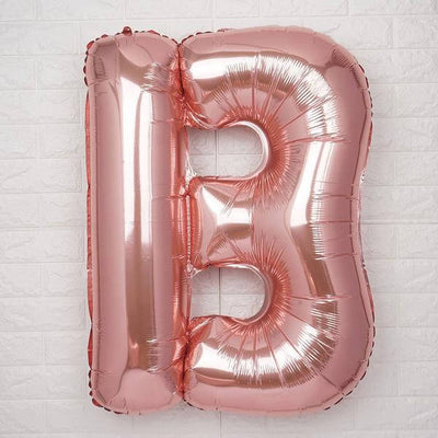 Rose gold number 13 balloon against a white background.
